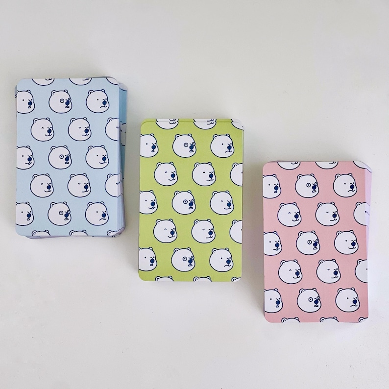 The backs of the three levels of card decks. Blue is for beginner, green is for intermediate, and red is for advanced.