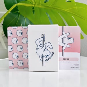 An advanced deck in a white box with a polar bear on a pole with the word "ADVANCED". The cards beside the box have polar bear illustrations. One of the card examples is a bear in an Alexa trick.
