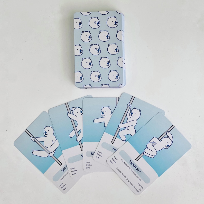 Examples of the deck of beginner blue cards. The card back is light blue with a pattern of white polar bear faces. The cards fanned out feature white polar bears in various beginner poses on a light blue background.