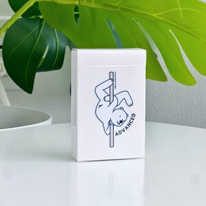 A white rectangular deck box featuring a cartoon polar bear on a pole, with the word "ADVANCED".