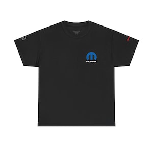 May include: Black t-shirt featuring the blue MOPAR logo on the chest. The shirt has short sleeves and a crew neck. Additional text is visible on the sleeves in white and red.