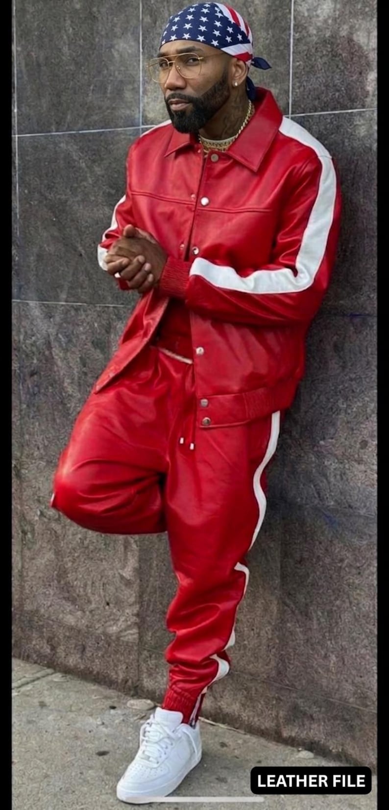 May include: Red leather jacket and matching pants with white stripes. The outfit includes a red and white bandana, gold-rimmed glasses, and white sneakers. The text "LEATHER FILE" is visible.
