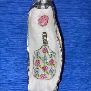Ostronskal decoupaget med vacker pickleball-design, kantat med silverfärg.