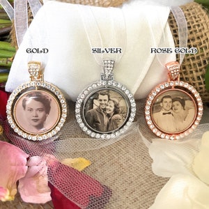 May include: Three round photo pendants in gold, silver, and rose gold. Each pendant features a black and white photo, surrounded by a ring of clear crystals. The pendants hang from white ribbons, with the words "GOLD", "SILVER", and "ROSE GOLD" above each.