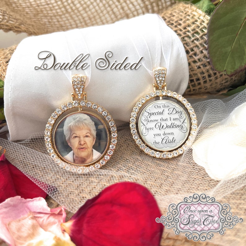 May include: Double-sided gold-tone pendant with a photo of a woman on one side and text on the other. The pendant is surrounded by clear crystals. The text reads "On this Special Day know that I am here Walking you down the Aisle."