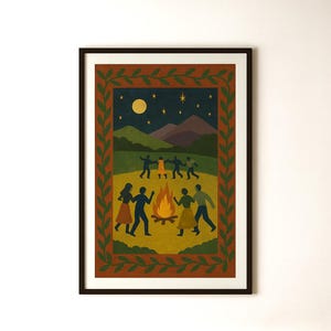May include: A framed art print depicting a nighttime scene with figures dancing around a bonfire. The artwork features a dark blue sky with a full moon and stars, and a border of green leaves. The figures are silhouetted.