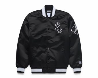May include: Black satin baseball jacket with white and gray striped trim on the collar, cuffs, and hem. Features the Chicago White Sox logo on the chest and a baseball diamond patch on the sleeve. Starter logo on the sleeve.