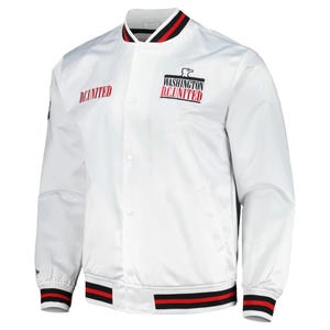 Peut inclure: Une veste style varsity blanche à boutons-pression avec le texte D.C. UNITED en rouge sur la poitrine droite et un logo Washington D.C. United avec un emblème d'aigle sur la poitrine gauche. Le col, les poignets et l'ourlet ont des rayures noires et rouges.