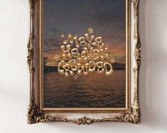 May include: A framed artwork featuring a sunset over water with the words "Make Heaven Crowded" in gold, bubble-style lettering. The ornate, gold-toned frame adds a vintage aesthetic to the piece, suitable for home decor.