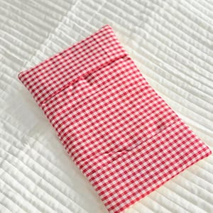 May include: A rectangular fabric pouch featuring a classic red and white gingham check pattern. The item has a folded top flap design and is constructed from a woven textile material with a consistent, repeating small-scale checkered print.