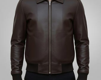 May include: A dark brown leather jacket with a zip-up front, a collar, and ribbed cuffs and hem. The jacket has a vertical panel design on the front and is worn with black pants.