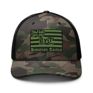May include: Camouflage baseball cap with a black mesh back. The front features a patch with a Hawaiian flag design in green and white, along with the text "Hawaiian Tactics". The cap is a classic trucker style.