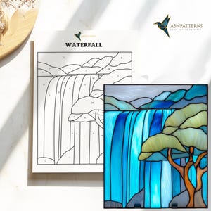 May include: A stained glass panel and a line drawing of a waterfall. The stained glass features a waterfall with blue water, green and yellow trees, and grey mountains. The line drawing is labelled "WATERFALL" and has numbered sections.