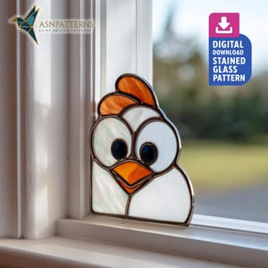May include: A stained glass chicken pattern, featuring a white body, orange comb and beak, and large blue eyes. The image includes the text "DIGITAL DOWNLOAD STAINED GLASS PATTERN". The design is displayed on a windowsill.