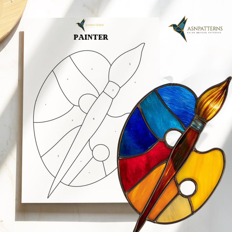 May include: A stained glass painter's palette and paintbrush with a white paper with the word "PAINTER" and a line drawing of the palette and brush. The palette is a mix of blue, red, orange, and yellow. The brush has a brown handle and yellow bristles.