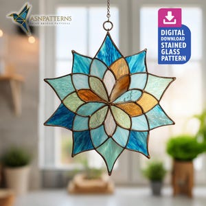 May include: A stained glass star-shaped suncatcher with a floral design. The suncatcher features shades of blue, green, and gold glass, with a dark metal frame. The image includes the text "DIGITAL DOWNLOAD STAINED GLASS PATTERN".