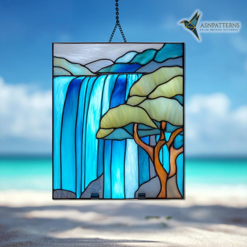 May include: Stained glass panel showing a waterfall and tree scene. The artwork uses blue, green, and brown hues, with a black border. The panel is suspended by a chain. The text "ASNPatterns" is visible.