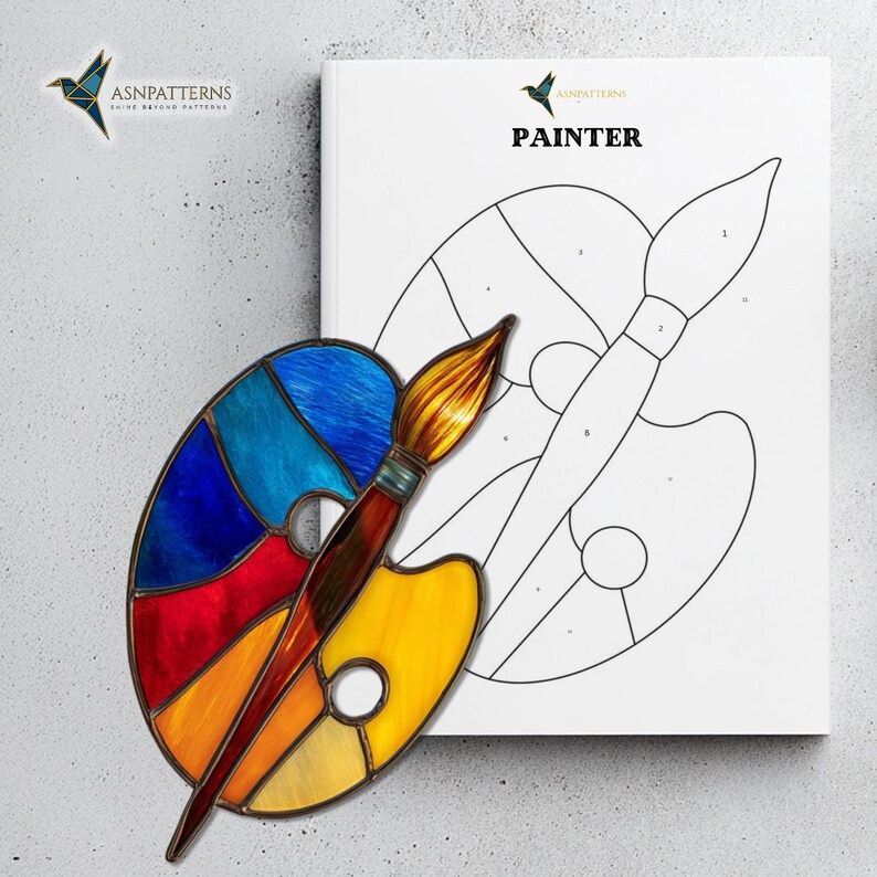 May include: A colorful stained glass palette and paintbrush are positioned in front of a coloring book page. The palette features red, blue, and yellow sections. The book cover reads "PAINTER" with the logo "ASNPatterns".