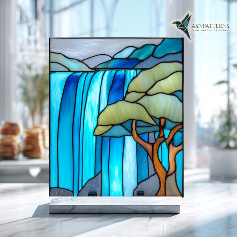 May include: Stained glass panel showing a waterfall and tree scene. The artwork uses blue, green, and brown hues. The panel is mounted on a white marble base. The text "ASNPatterns" is visible in the upper right corner.