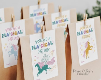 May include: Several brown paper gift bags with white tags clipped on with wooden clothespins. The tags read "You're a Magical Friend" with unicorn illustrations and the word "Love". The text "Rose & Fern Printable" is on the bottom right.