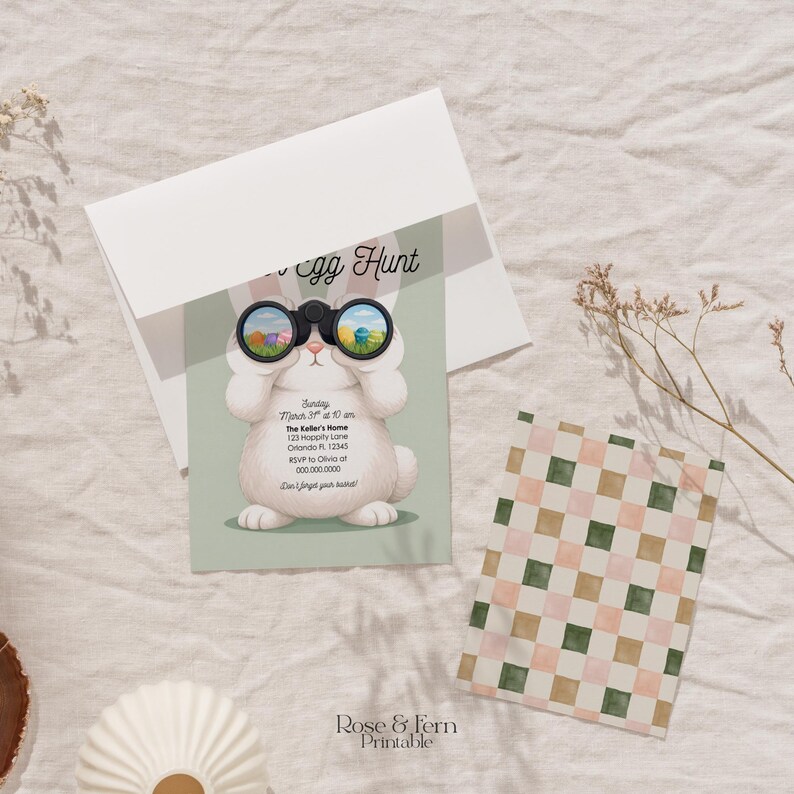 May include: An Easter-themed invitation with a cartoon bunny holding binoculars, with the text "Egg Hunt". The invitation is light green with white text. A patterned gift bag and a white envelope are also present.