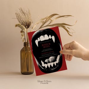 May include: A red Halloween party invitation with a black open mouth graphic featuring sharp white fangs. The invitation includes the text "BOOS & BITES", party details, and the words "DRESS TO IMPRESS (OR TERRIFY)".