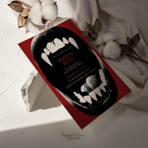 May include: A red Halloween party invitation with a black illustration of a snarling mouth with sharp white teeth. The invitation includes the text "BOOS & BITES" and party details.