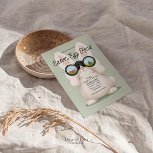 May include: An Easter Egg Hunt invitation featuring a cartoon bunny with binoculars, set against a light green background. The invitation includes event details and the text "Hop on over for an Easter Egg Hunt". A speckled bowl is in the background.