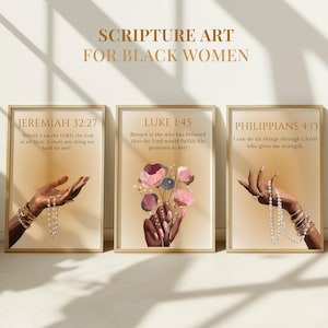 May include: Three framed scripture art prints. Each print has a gold frame and a beige background. The prints display text from Jeremiah, Luke, and Philippians, with illustrations of hands and flowers. The text at the top reads "SCRIPTURE ART FOR BLACK WOMEN."