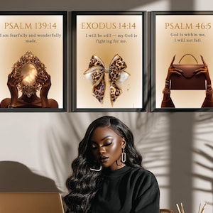 May include: Three framed art prints with inspirational quotes. The first features a gold mirror, the second a leopard print bow, and the third a brown handbag. Each print has a different Bible verse in black text against a beige background.