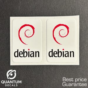 May include: Two white rectangular stickers with the word "debian" in black font. Each sticker has a red swirl design above the word. The stickers are on a white backing. The logo for "QUANTUM DECALS" is in the lower left corner.