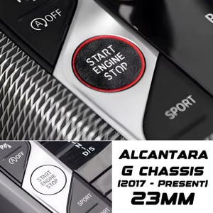May include: Close-up of a car's interior with a black and silver dashboard. The start/stop button is a red-ringed circle with white text. The text "START ENGINE STOP" is visible. The text "SPORT" is also visible. The text "ALCANTARA G CHASSIS (2017 - PRESENTI) 23MM" is also visible.
