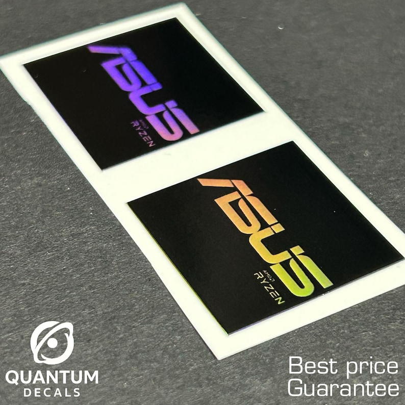 May include: Two rectangular stickers with the ASUS logo and "RYZEN" text in a gradient color scheme on a black background. The stickers are on a white background. The text "QUANTUM DECALS" and "Best price Guarantee" are also visible.