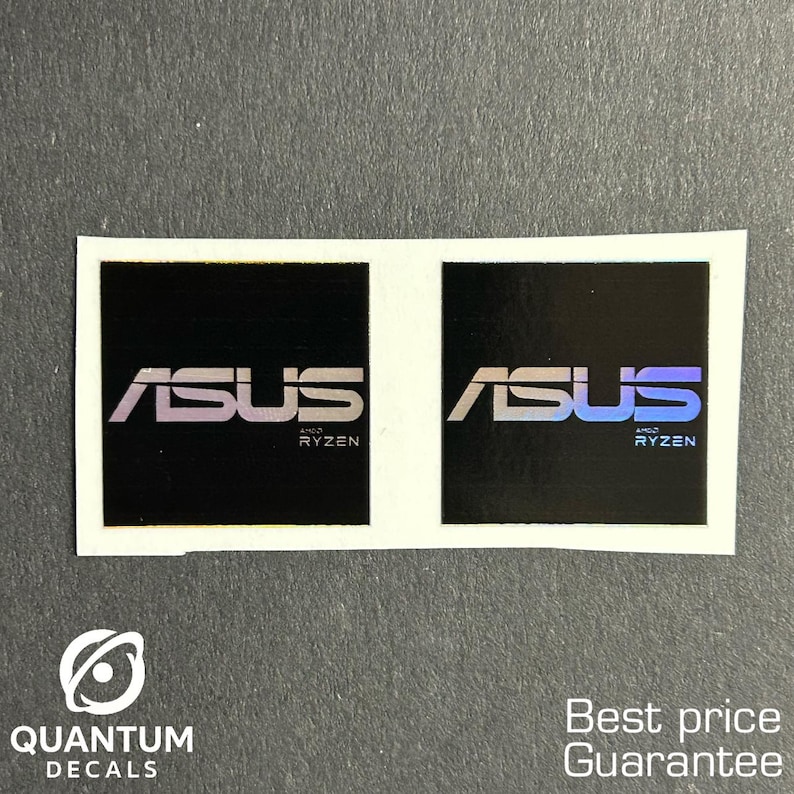 May include: Two black square stickers with the ASUS logo and "Ryzen" text in white and purple. The stickers are on a white background. The bottom left corner has a logo that says "QUANTUM DECALS".