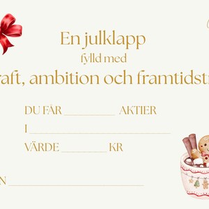 May include: A cream-colored gift certificate with gold text and a red bow. The text reads "En julklapp fylld med kraft, ambition och framtidstro." A mug of hot chocolate with a gingerbread man is in the corner.