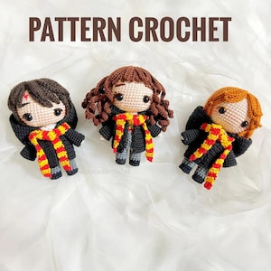 May include: Three crocheted dolls with black robes and striped scarves in red, yellow, and black. Each doll has a different hair color: brown, auburn, and red. The text "PATTERN CROCHET" is displayed above the dolls.