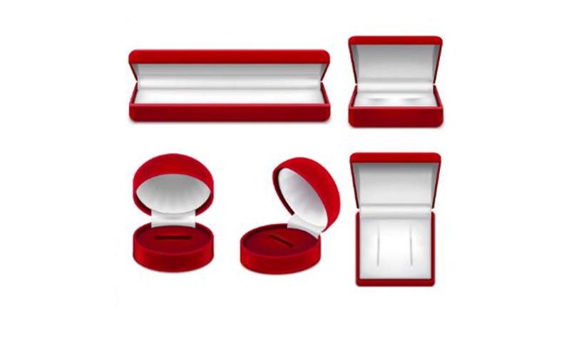 May include: A collection of red velvet jewelry boxes in various shapes and sizes, including rectangular and round designs. The boxes are open and closed, revealing white interiors, perfect for rings, necklaces, and other small items.