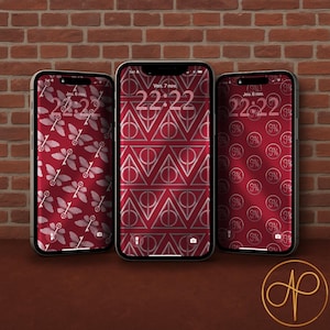Peut inclure: Trois smartphones avec des fonds d'écran à motifs rouges et blancs. Les écrans affichent l'heure et la date, avec le texte "Ven. 7 nov." et "Jeu. 6 nov." visibles. Les fonds d'écran présentent des motifs répétés de clés, de formes géométriques et de cercles.