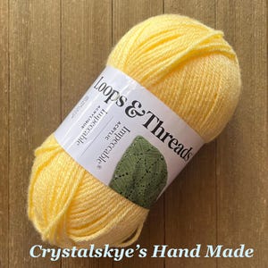 May include: A set of three ceramic mugs with a speckled, matte finish. The mugs are in shades of cream, light gray, and dark gray. Each mug has a simple, minimalist design and a rounded handle.