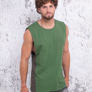 May include: A sleeveless shirt with a green and brown geometric pattern. The shirt has a relaxed fit and a rounded neckline.
