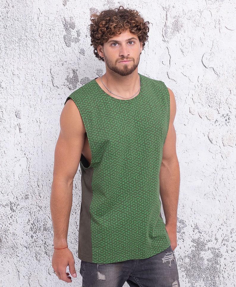 May include: A sleeveless shirt with a green and brown geometric pattern. The shirt has a relaxed fit and a rounded neckline.