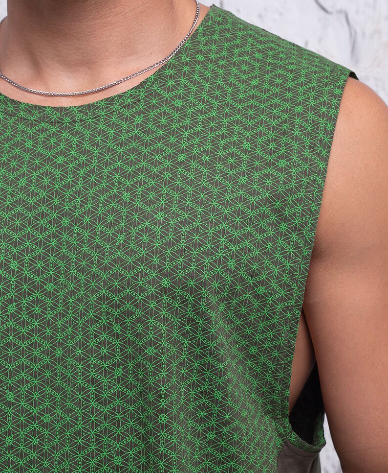 May include: A sleeveless shirt with a green and brown geometric pattern. The pattern is a repeating design of small circles and lines.