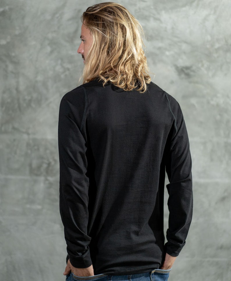 May include: A black long-sleeved shirt with a crew neck.