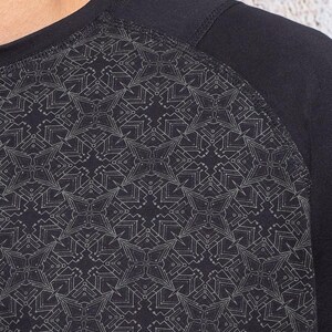 May include: Black long-sleeve shirt with a geometric pattern in a lighter shade of gray.