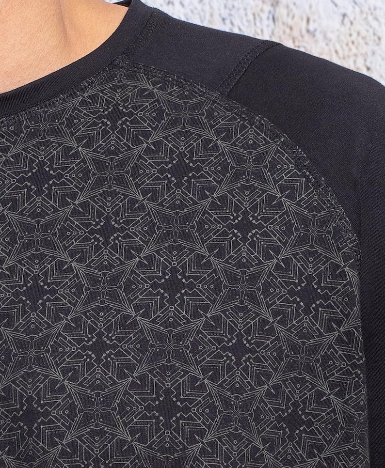 May include: Black long-sleeve shirt with a geometric pattern in a lighter shade of gray.