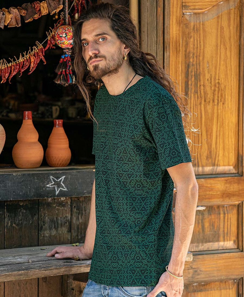 May include: A dark green t-shirt with a geometric pattern. The shirt has a crew neck and short sleeves.