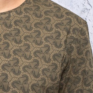 May include: A green long-sleeved shirt with a brown and black abstract pattern.