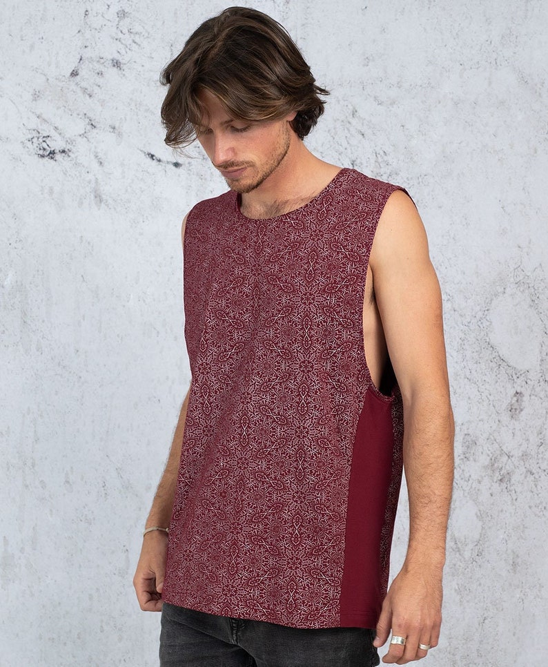 Puede incluir: Una camiseta sin mangas con fondo burdeos y un patr&oacute;n geom&eacute;trico blanco. La camiseta tiene un panel burdeos liso en el lado derecho.