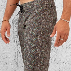May include: Black swim trunks with a colorful paisley pattern.