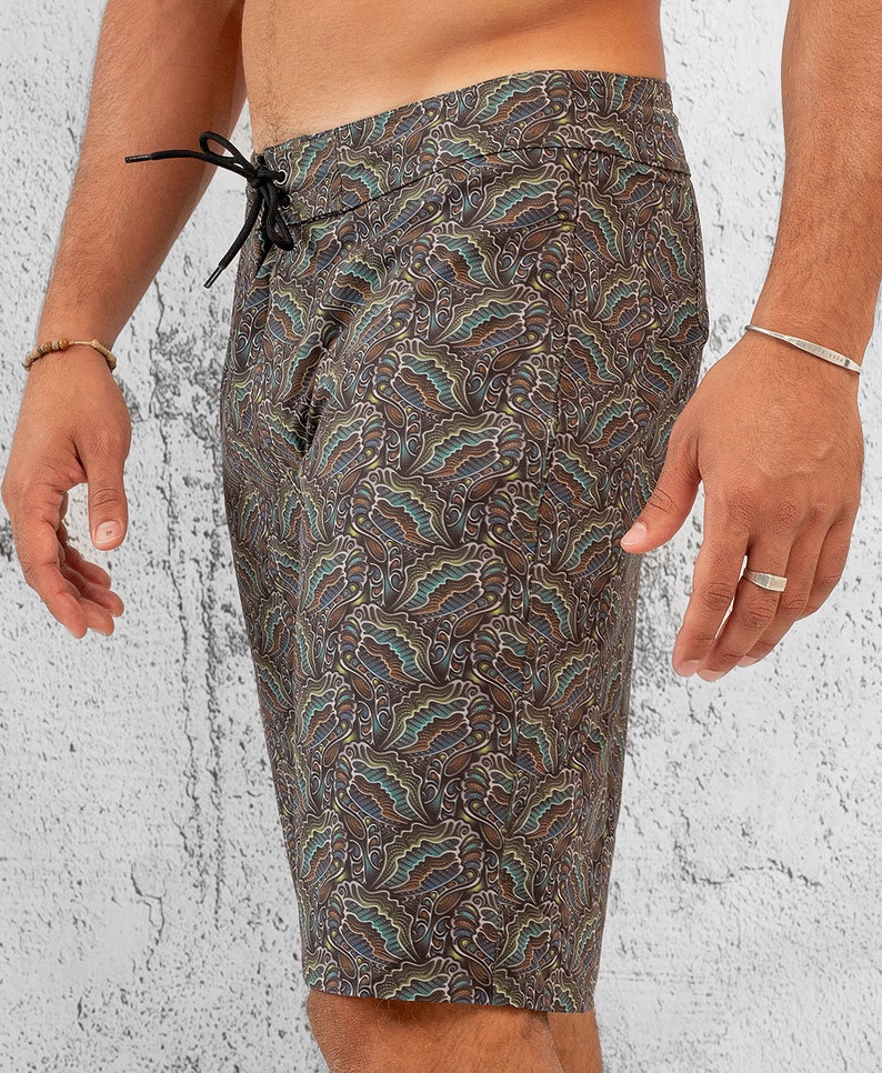 May include: Black swim trunks with a colorful paisley pattern.